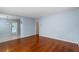 Hardwood floor living room, light blue walls, and view to kitchen at 514 S Crystal Lake Dr, Orlando, FL 32803