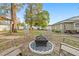 A backyard with a fire pit and chairs, picnic table, and white fence at 5607 Huber Dr, Orlando, FL 32818