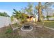 A spacious backyard featuring a fire pit surrounded by chairs and a shed at 5607 Huber Dr, Orlando, FL 32818