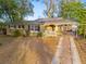 Inviting single-story home with solar panels, a convenient carport, and a well-maintained front yard, offering both curb appeal and energy efficiency at 5607 Huber Dr, Orlando, FL 32818