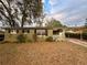 Charming single-story home featuring a quaint front yard and attached carport for convenient parking at 5607 Huber Dr, Orlando, FL 32818
