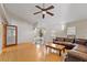Bright living room featuring hardwood floors, a vaulted ceiling, and large windows, creating a warm and welcoming gathering space at 5607 Huber Dr, Orlando, FL 32818