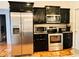 Stainless steel appliances and dark wood cabinets highlight this kitchen at 567 Rachael Court, Oviedo, FL 32765