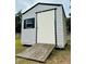 White vinyl storage shed with ramp access at 567 Rachael Court, Oviedo, FL 32765