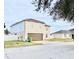 Two-story house with brown garage door and white fence at 5861 Windridge Dr, Winter Haven, FL 33881