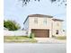 Two-story house with brown garage door and white fence at 5861 Windridge Dr, Winter Haven, FL 33881