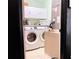Laundry room with washer, dryer, and storage cabinets at 5861 Windridge Dr, Winter Haven, FL 33881