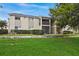 Back exterior view of condo building showcasing landscaping and lawn at 912 Lake Destiny Rd # G, Altamonte Springs, FL 32714