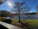 Sunny lake view from condo balcony, featuring a large tree at 912 Lake Destiny Rd # G, Altamonte Springs, FL 32714
