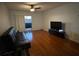 Living room with hardwood floors, a sofa, and a large TV at 912 Lake Destiny Rd # G, Altamonte Springs, FL 32714