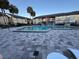 Community pool with lounge chairs and surrounding brick patio at 912 Lake Destiny Rd # G, Altamonte Springs, FL 32714
