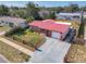Aerial view of home featuring a red roof, well-maintained yard, and charming front fence at 930 Lewis Dr, Daytona Beach, FL 32117