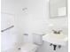 Bathroom with a white tiled shower and walls, a toilet, and a sink at 930 Lewis Dr, Daytona Beach, FL 32117
