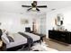 Staged primary bedroom with a modern design, hardwood floors, and a ceiling fan at 930 Lewis Dr, Daytona Beach, FL 32117