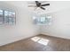 Bright bedroom featuring wood-look floors, base molding, ceiling fan, and multiple windows at 930 Lewis Dr, Daytona Beach, FL 32117