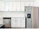 Modern kitchen with stainless steel appliances, white cabinetry, and white quartz countertops at 930 Lewis Dr, Daytona Beach, FL 32117