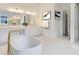 Spa-like bathroom with a large soaking tub and modern fixtures at 9847 Laurel Berry Dr, Orlando, FL 32827