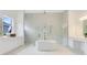 Luxurious bathroom with a soaking tub and marble shower at 9847 Laurel Berry Dr, Orlando, FL 32827