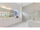 Elegant bathroom featuring a freestanding tub and dual vanity at 9847 Laurel Berry Dr, Orlando, FL 32827