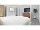 Bright bedroom with large TV and ensuite bathroom at 9847 Laurel Berry Dr, Orlando, FL 32827