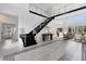 Modern two-story foyer with sleek staircases and glass railings at 9847 Laurel Berry Dr, Orlando, FL 32827