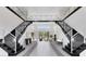 Elegant two-story entryway with a double staircase and modern light fixtures at 9847 Laurel Berry Dr, Orlando, FL 32827