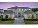 Stunning two-story home featuring a symmetrical facade, attached garages, and professional landscaping at 9847 Laurel Berry Dr, Orlando, FL 32827
