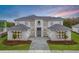 Gorgeous two-story home boasting manicured lawns, symmetrical design, and a paver driveway at 9847 Laurel Berry Dr, Orlando, FL 32827