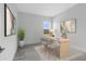 Modern home office with wood desk and gray chairs at 9847 Laurel Berry Dr, Orlando, FL 32827
