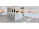 Spacious kitchen with white cabinets, marble countertops and island at 9847 Laurel Berry Dr, Orlando, FL 32827