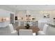 Modern white kitchen with large island and stainless steel appliances at 9847 Laurel Berry Dr, Orlando, FL 32827