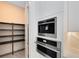 Walk-in pantry with ample shelving for storage at 9847 Laurel Berry Dr, Orlando, FL 32827