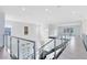 Open upper landing with glass railings and modern light fixture at 9847 Laurel Berry Dr, Orlando, FL 32827