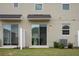 Home's back exterior with sliding glass door at 1153 Seaside Mist Trl, Kissimmee, FL 34747