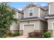 Townhouse exterior with garage and landscaping at 1153 Seaside Mist Trl, Kissimmee, FL 34747