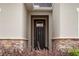 Dark brown front door with stone accents at 1153 Seaside Mist Trl, Kissimmee, FL 34747