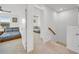 Upstairs hallway with two bedrooms and a staircase leading down at 1153 Seaside Mist Trl, Kissimmee, FL 34747