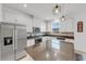 Modern kitchen with white cabinets, granite countertops and stainless steel appliances at 1153 Seaside Mist Trl, Kissimmee, FL 34747