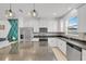 Modern kitchen with white cabinets, granite countertops, and stainless steel appliances at 1153 Seaside Mist Trl, Kissimmee, FL 34747
