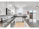 Modern kitchen with white cabinets, granite countertops, and stainless steel appliances at 1153 Seaside Mist Trl, Kissimmee, FL 34747