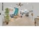 Open living room with teal accent wall, comfy seating, and view of kitchen at 1153 Seaside Mist Trl, Kissimmee, FL 34747