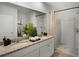 Double vanity bathroom with granite countertop and shower at 1328 Hanoverian Dr, Lake Alfred, FL 33850