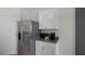 Stainless steel refrigerator and white cabinetry with granite countertop at 1328 Hanoverian Dr, Lake Alfred, FL 33850