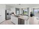 Open kitchen with island, stainless steel appliances, and view of dining area at 1328 Hanoverian Dr, Lake Alfred, FL 33850
