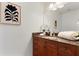 Bathroom with neutral paint, granite countertop vanity, framed mirror and ample lighting at 150 E Robinson St # 1011, Orlando, FL 32801