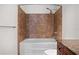 Bathroom features a tub with a tiled shower with neutral colors at 150 E Robinson St # 1011, Orlando, FL 32801