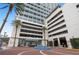 Modern building exterior with water feature and palm trees at 150 E Robinson St # 1011, Orlando, FL 32801