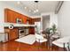 Well-lit kitchen features stainless steel appliances, wood cabinets, and an adjacent dining area at 150 E Robinson St # 1011, Orlando, FL 32801