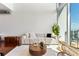 Bright living room with modern white sofa, stylish rug, hardwood floors, and stunning view at 150 E Robinson St # 1011, Orlando, FL 32801