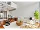 Bright living room with stylish furniture, spiral staircase, hardwood floors, and open floor plan at 150 E Robinson St # 1011, Orlando, FL 32801